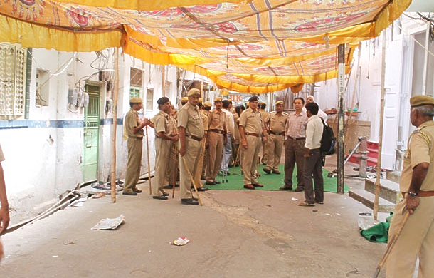 After the attack: police stand outside the Moyyiadpura masjid.